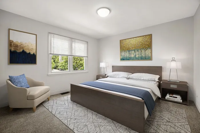 Inviting bedroom with a modern wooden bed, elegant decor, and natural light pouring through large windows.