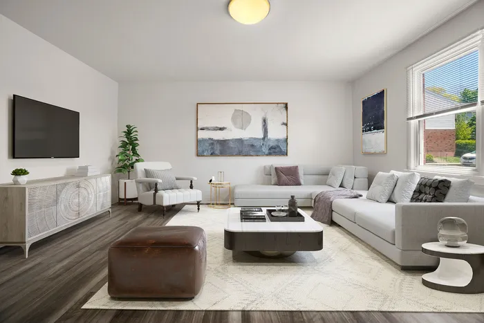 Modern living room with elegant gray sectional sofa, chic armchair, and stylish decor featuring abstract art pieces.
