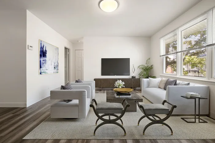 Bright, modern living room with elegant furniture, large windows, and contemporary decor, creating a welcoming atmosphere.