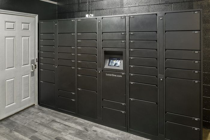 Modern package locker system with digital interface in a sleek black finish, enhancing convenience and security.