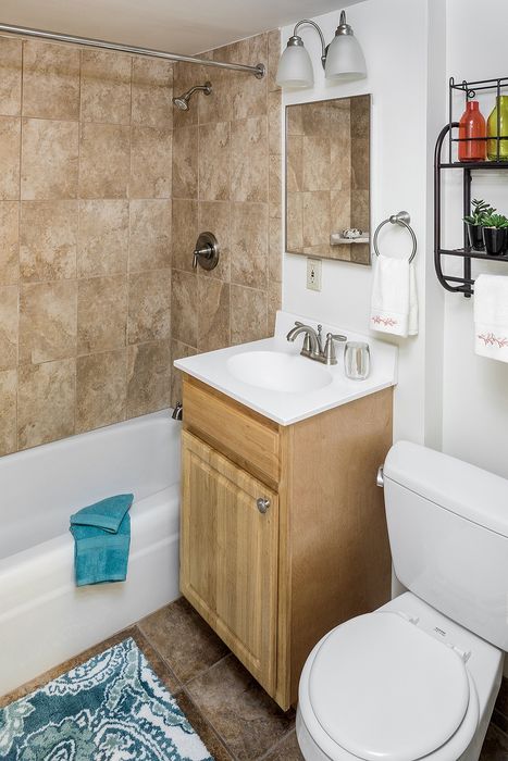 Inviting bathroom with elegant tilework, modern fixtures, and a cozy ambiance perfect for relaxation.