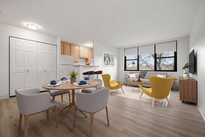 Modern apartment interior showcasing a bright open-plan living and dining area with stylish furniture, large windows, and a cozy kitchen.