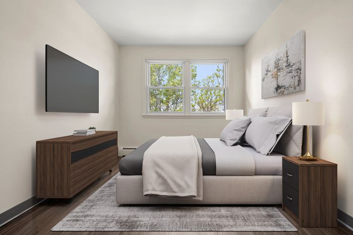 Bright and inviting bedroom featuring a plush bed, elegant decor, modern dresser, and large window with scenic views.