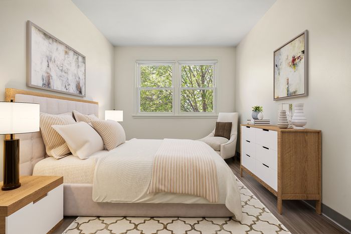 Chic and serene bedroom with cozy bed, modern artwork, and inviting natural light.