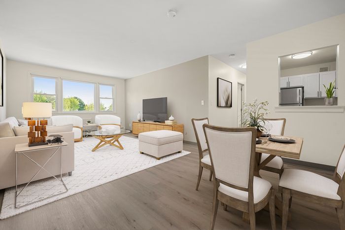Bright and inviting living space with modern decor, featuring a cozy dining area and open kitchen design.