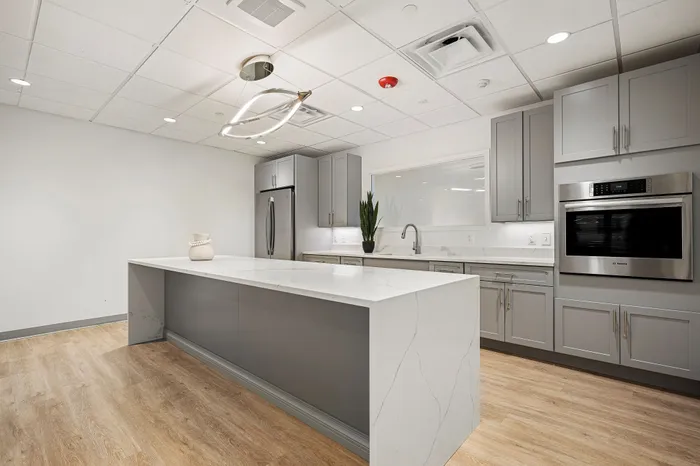 Sleek modern kitchen featuring a marble island, stainless steel appliances, and elegant cabinetry, perfect for entertaining.