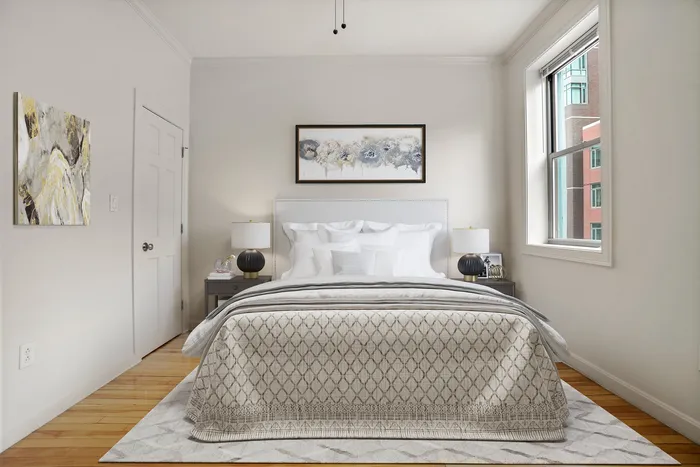 Elegant bedroom with modern decor, featuring a plush bed and stylish artwork, filled with natural light from a large window.