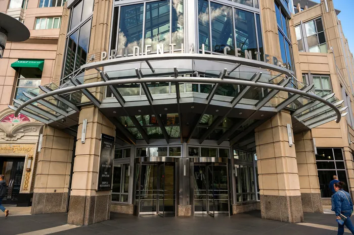 Elegant entrance of a modern commercial building with glass and steel elements, offering a welcoming atmosphere.