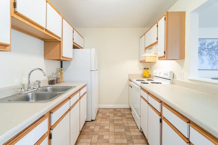 Bright and inviting kitchen with sleek countertops, modern appliances, and ample cabinet space for storage.