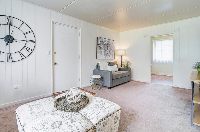 Charming living room with a cozy sofa, stylish decor, and inviting natural light.