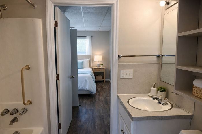 Bright bathroom with updated vanity and lighting at Colonial Park Apartments in Summerville