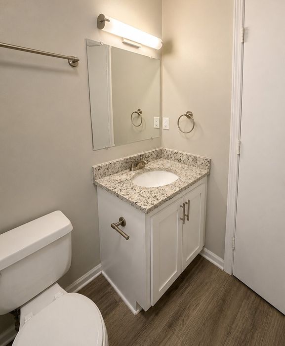 Modern bathroom with elegant granite countertop, stylish vanity, and sleek fixtures.