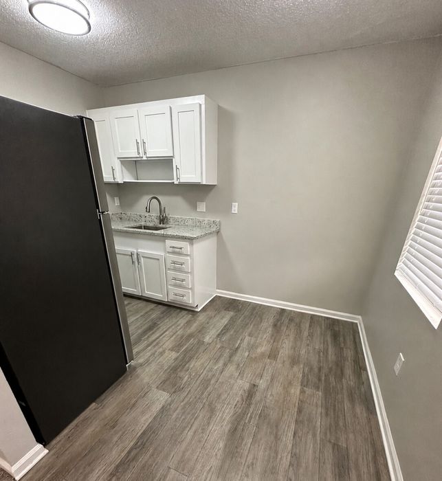 Chic kitchen with modern cabinetry, sleek stainless steel appliances, and elegant wood flooring.