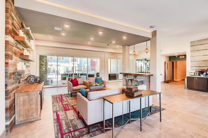 Inviting contemporary lounge area with stylish seating, modern decor, and abundant natural light, perfect for relaxation and social gatherings.