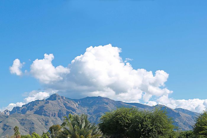 Serene mountain landscape with lush greenery and vibrant blue sky, perfect for nature lovers.