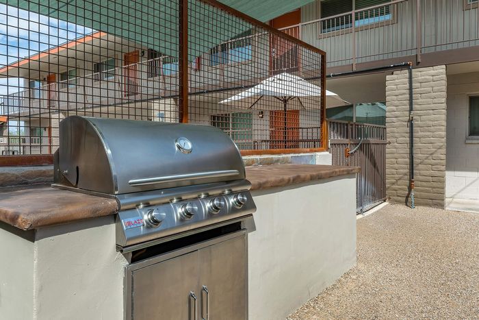 Chic outdoor area featuring a sleek stainless steel grill, perfect for entertaining and enjoying sunny barbecues.