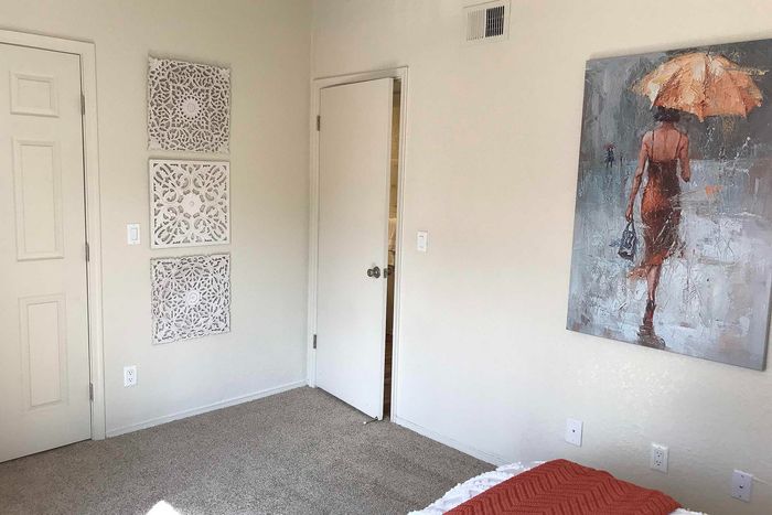 Inviting bedroom featuring chic wall art and elegant decorative panels, offering a warm and cozy atmosphere.
