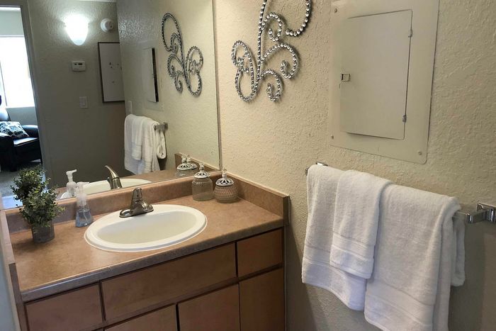 Elegant bathroom with a modern sink, stylish mirror accents, and plush towels offering a serene retreat.