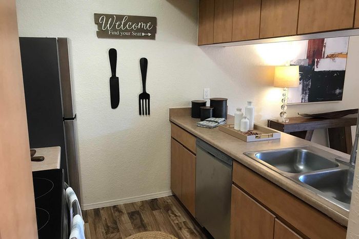 Charming kitchen nook featuring elegant cabinetry, modern appliances, and cozy decor with warm lighting.