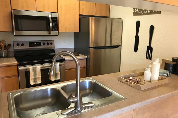 Modern kitchen featuring sleek stainless steel appliances, stylish cabinetry, and a spacious countertop with a polished finish.