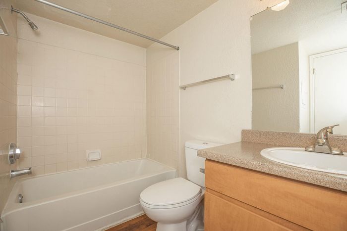 Elegant bathroom featuring a pristine bathtub, modern fixtures, and a stylish countertop for a cozy, luxurious experience.