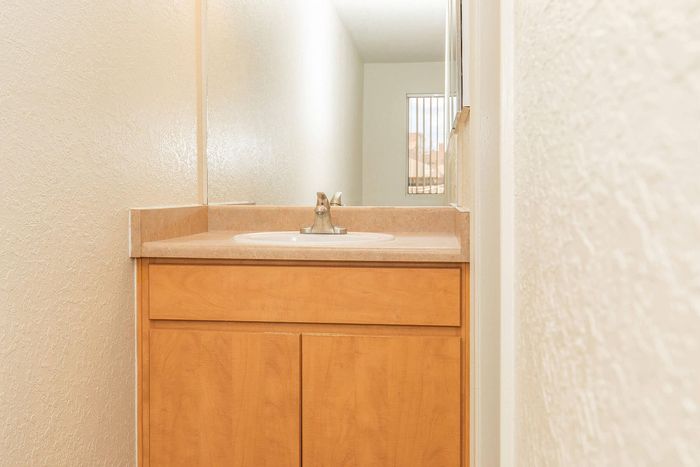 Bright and modern bathroom vanity with elegant wood cabinetry and a sleek sink design.