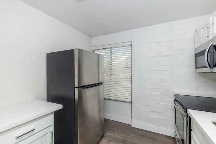 Contemporary kitchen with sleek stainless steel appliances and elegant white cabinetry, offering a bright and inviting culinary space.