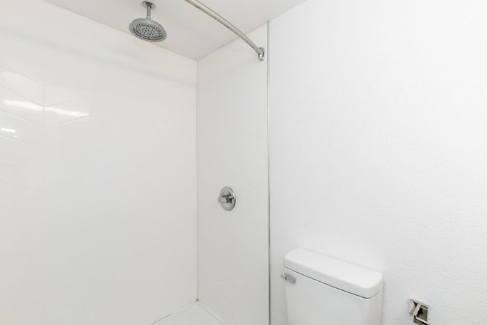 Modern bathroom with sleek white shower and contemporary fixtures.