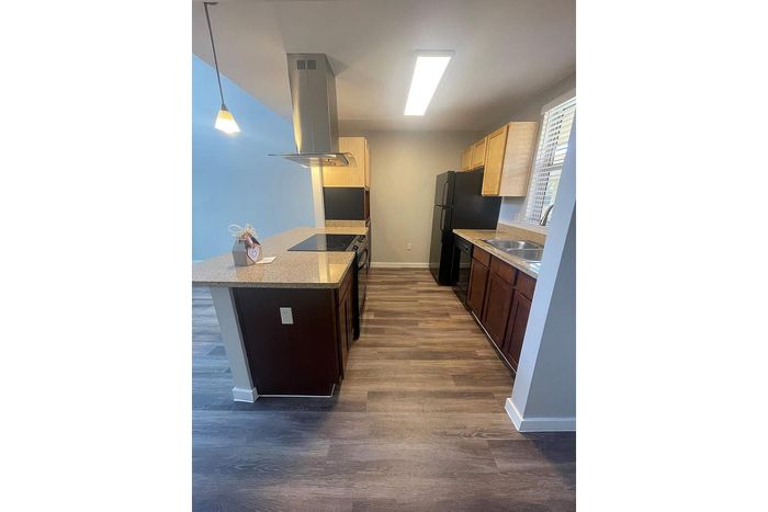 Contemporary kitchen with sleek countertops, stylish cabinetry, and modern appliances, offering a cozy and functional space.