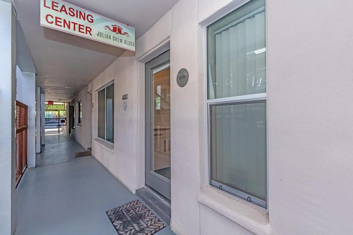 Inviting exterior of modern leasing center at The Julian Drew Block with clean lines and welcoming entrance.