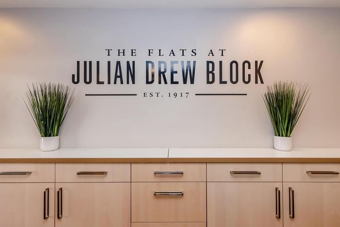 Elegant modern cabinet decor with minimalist greenery at Julian Drew Block, established 1917.