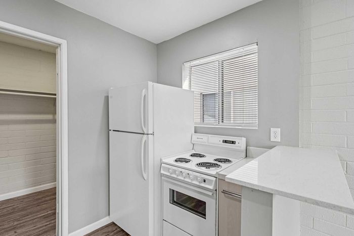 Contemporary kitchen featuring sleek appliances, spacious refrigerator, and bright natural lighting.