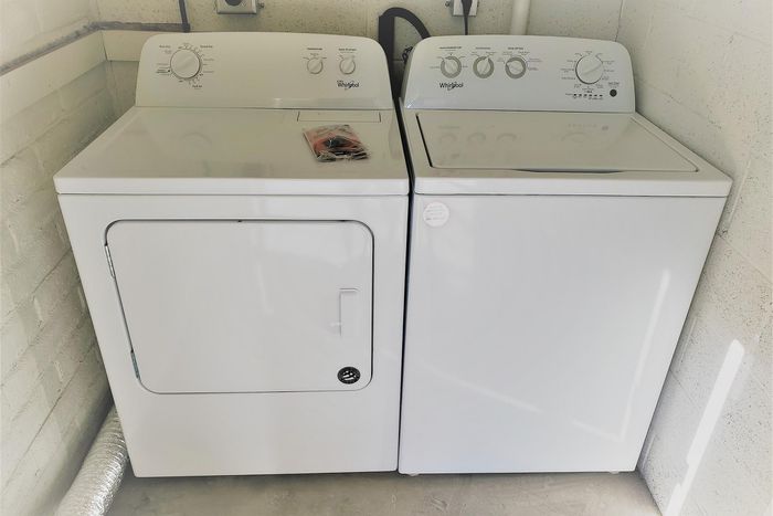 Modern laundry room featuring energy-efficient Whirlpool washer and dryer set, offering convenience and style.