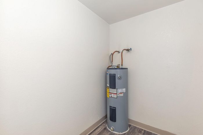 Modern interior showcasing an efficient water heater in a clean, spacious utility room with sleek flooring.