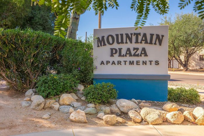 Welcome to Mountain Plaza Apartments, a serene community with lush greenery and desert charm.