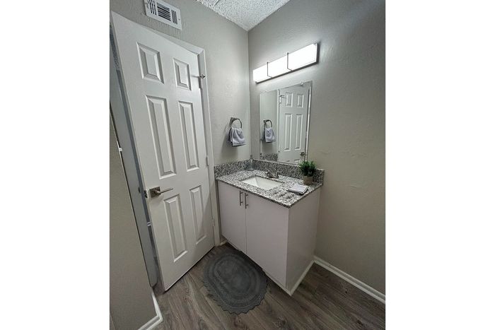 Chic bathroom with elegant granite countertop, modern fixtures, and stylish decor.