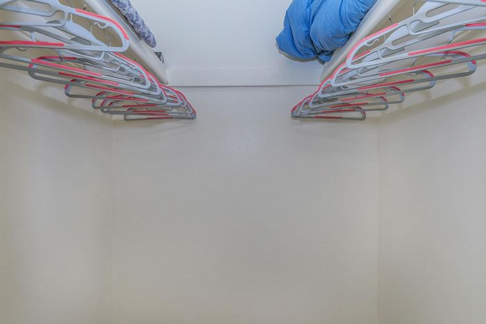 Spacious and bright closet featuring multiple hangers and ample storage space, ideal for organizing your wardrobe.