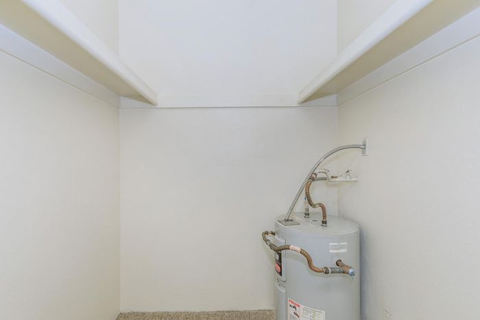 Utility space with an efficient water heater in a neatly designed corner, offering practical functionality for modern living.
