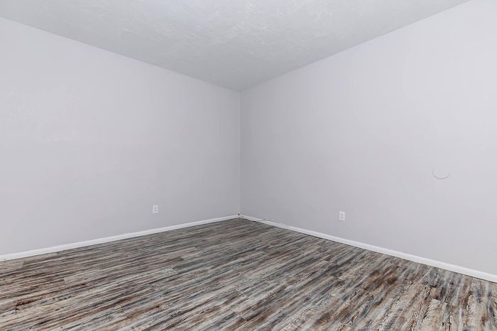 Modern room with elegant gray walls and beautiful weathered wood flooring, perfect for a cozy living space.