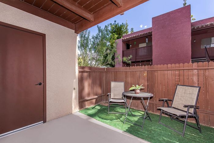 Charming patio space with cozy seating and vibrant landscaping, perfect for relaxation and outdoor enjoyment.