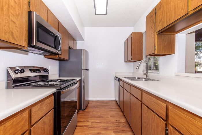 Modern kitchen with sleek appliances, wooden cabinets, and elegant countertops, perfect for culinary creativity.