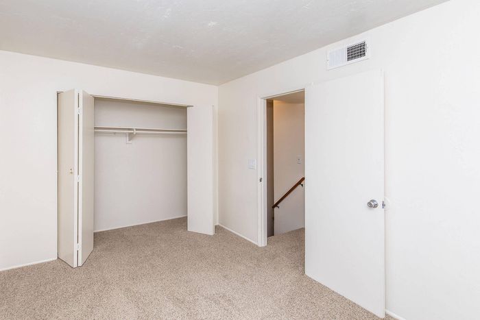 Bright, inviting bedroom with fresh carpet and expansive closet space, perfect for modern living.
