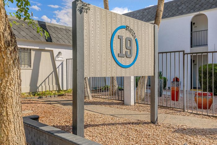 Inviting entrance to Station 19 apartments featuring modern signage and a charming courtyard.