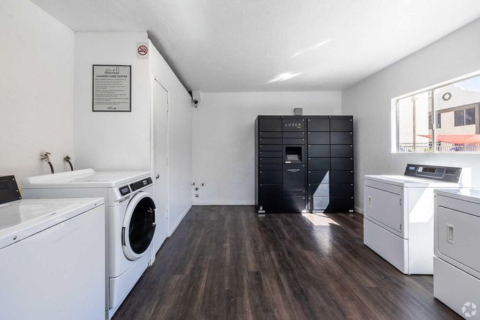 Bright and modern laundry care center with high-efficiency washers, dryers, and secure package lockers.
