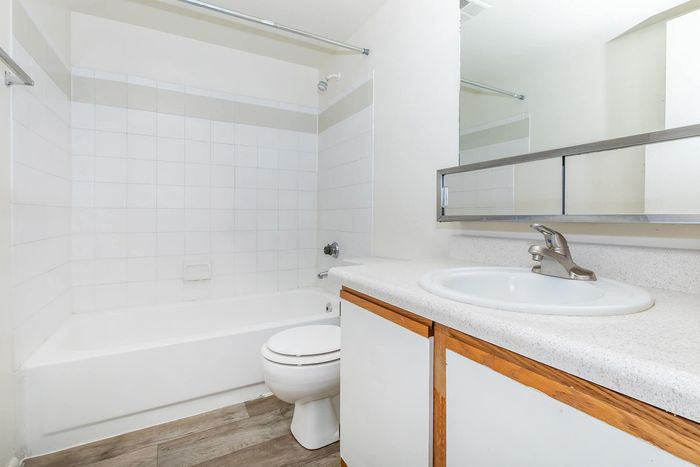 Bright, modern bathroom featuring a sleek vanity, spacious bathtub, and elegant ceramic tiles, perfect for relaxation.