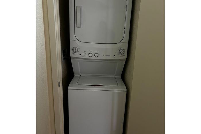 Compact and efficient in-unit laundry setup featuring a sleek stacked washer and dryer.