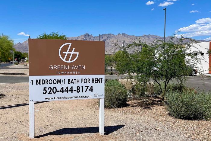 Greenhaven Townhomes sign offering 1 bedroom, 1 bath rentals with scenic mountain views in the background.