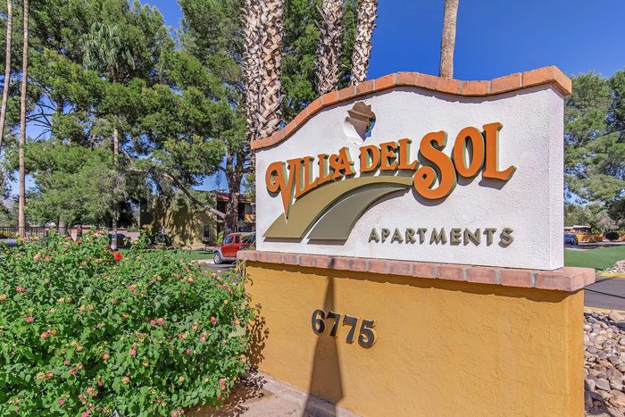 Welcome to Villa del Sol Apartments, nestled among lush greenery with a vibrant exterior and welcoming atmosphere, perfect for a serene lifestyle.