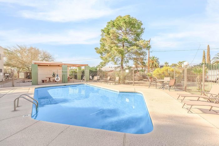 Inviting outdoor pool area with comfortable lounge seating and vibrant greenery in a serene setting.