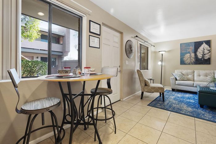 Inviting living room with natural light, cozy seating, and stylish decor, perfect for relaxation and conversation.